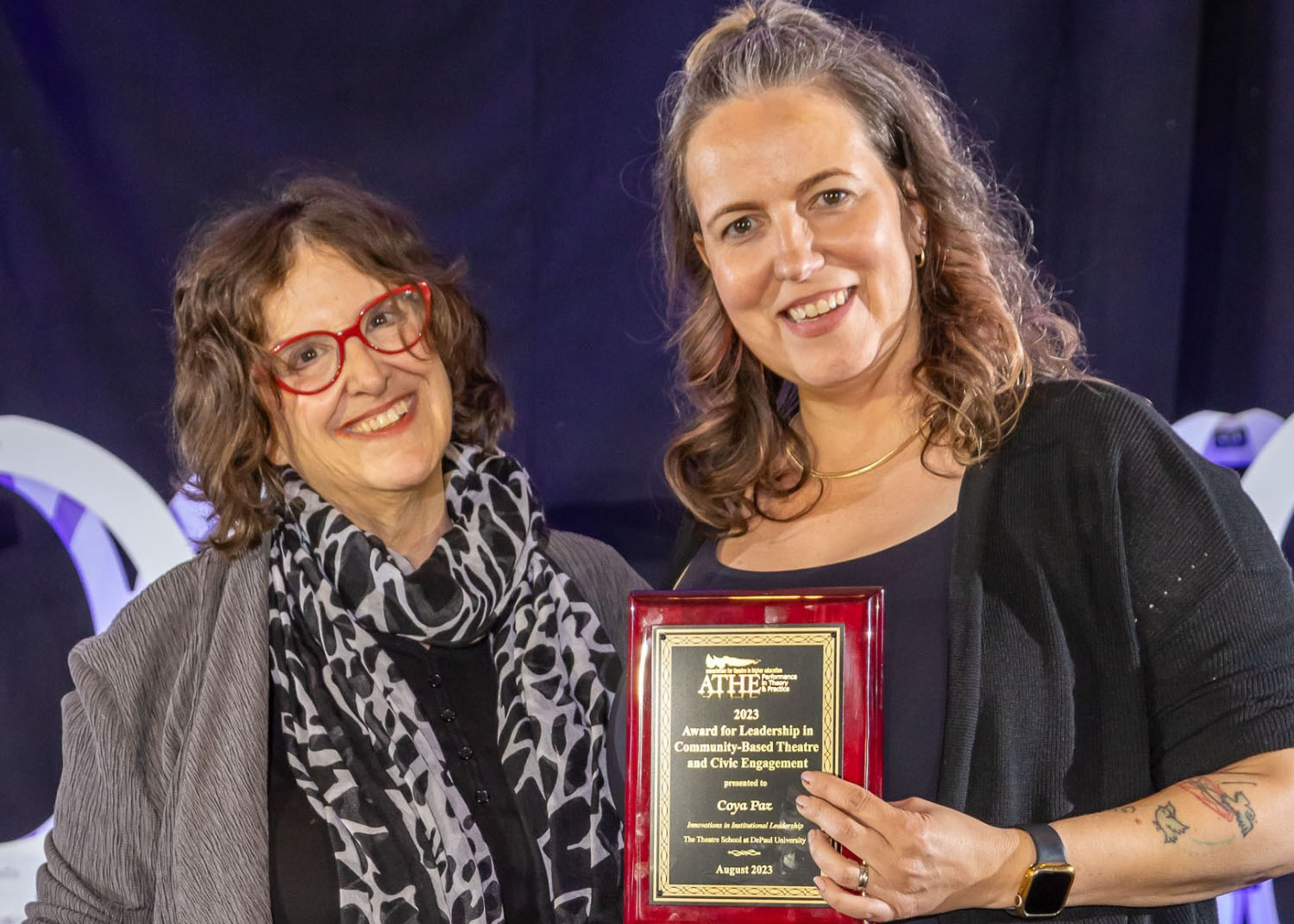 Coya Paz receives award from Joan Lipkin,the ATHE awards committee co-chair.