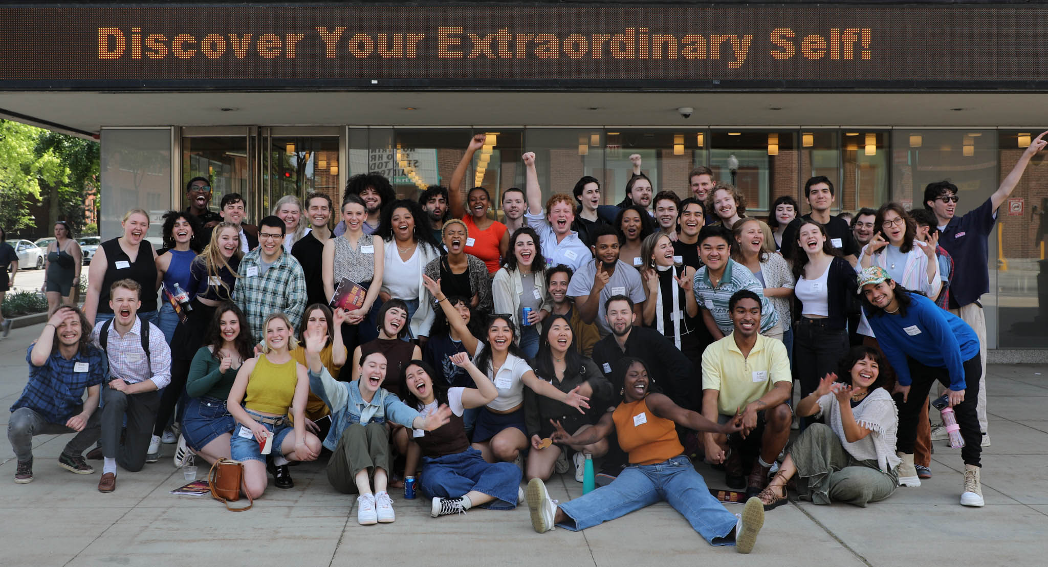 Graduate Showcase Class of 2023 Class Photo in front of The Theatre School. Marquee reads 