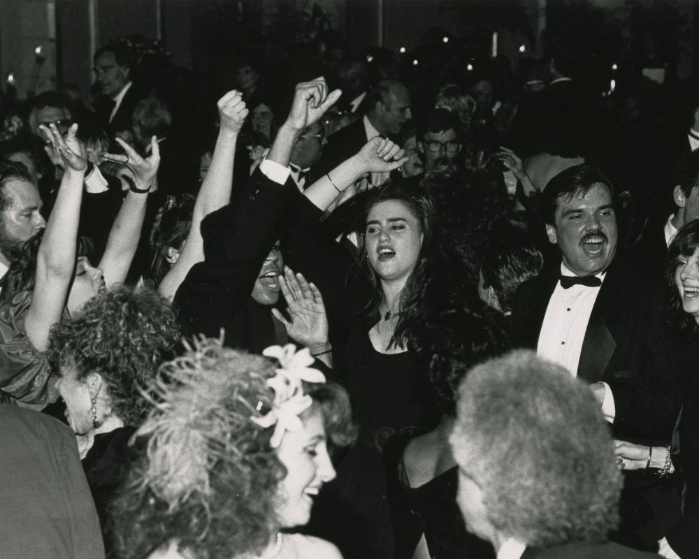 A black and white photo of a large crowd of people dancing.