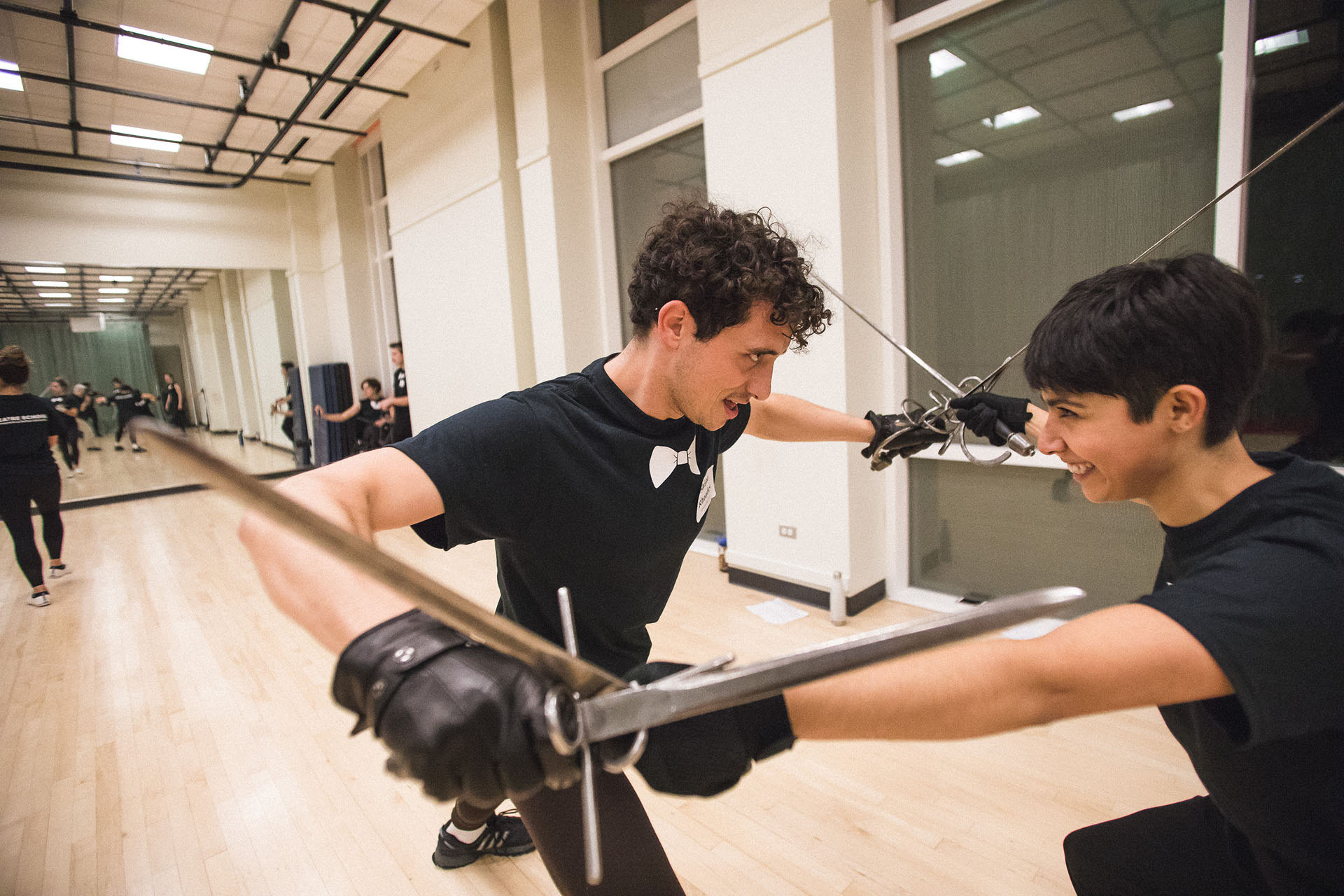 Students demonstrate stage combat techniques for guests.